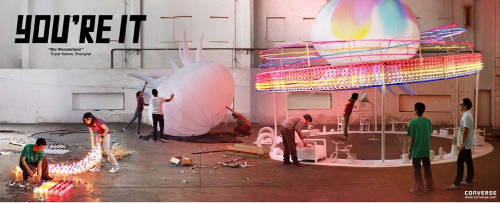 Artists constructing a glowing installation from rows of lights